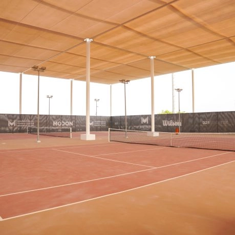 Mouratoglou Tennis Center Hudayriyat Island court overlooking the Arabian Gulf under the soft Abu Dhabi light.
